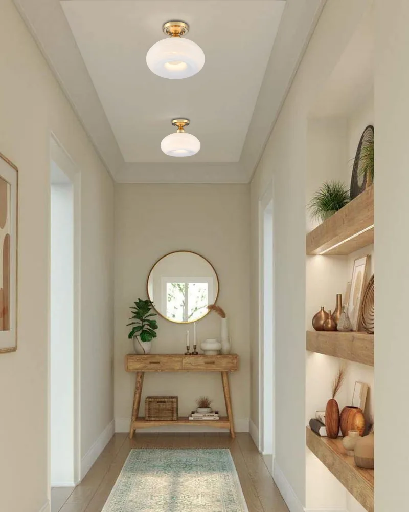 Two modern semi-flush mount ceiling lights with gold bases from Dreamsidea, illuminating a long, elegant hallway.
