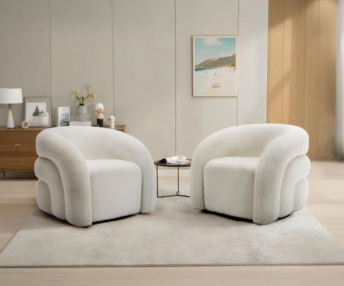A pair of modern sculptural armchairs from Dreamsidea, upholstered in cozy white boucle fabric.