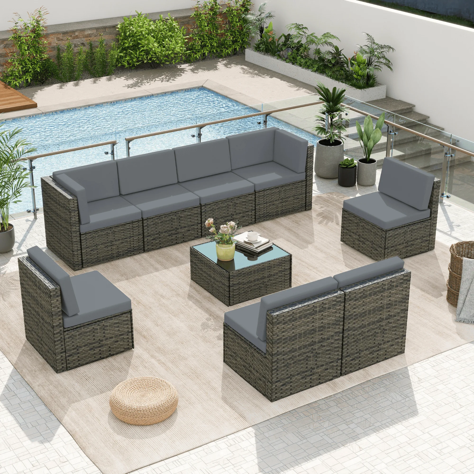 A grey wicker outdoor sectional sofa set from Dreamsidea's lounge furniture collection on a poolside patio.